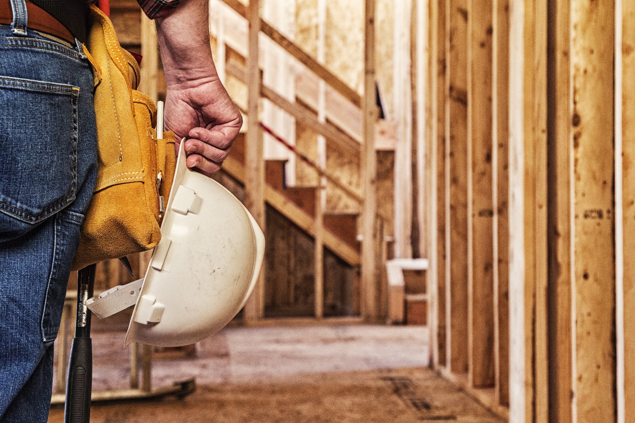 Subcontractor Construction Lien - Worker Closeup with Hardhat in Hand