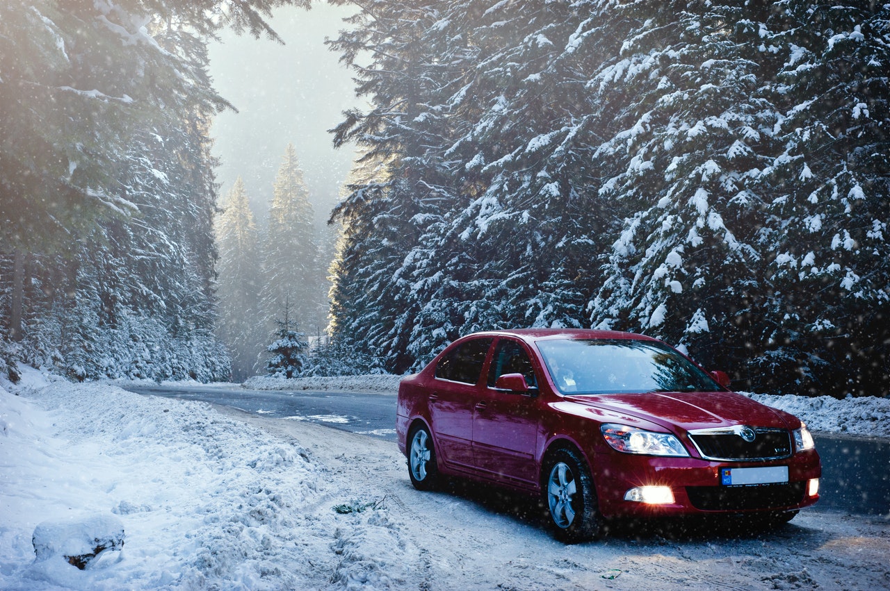 A car on a snowy road in winter representing tips to stay safe and avoid injury