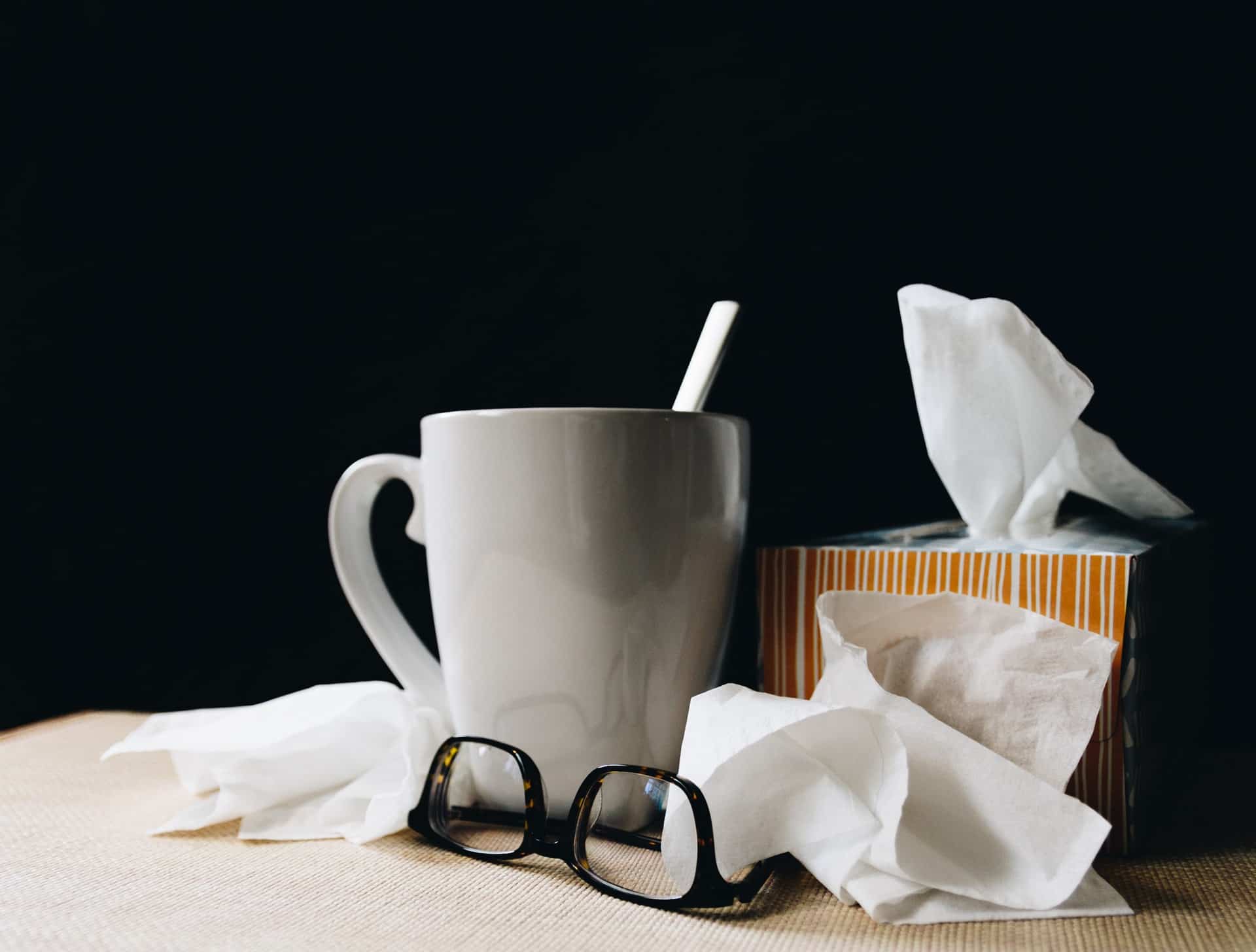 Tissues and a mug representing paid leave in Ontario for employees who are sick or required to stay home due to COVID-19