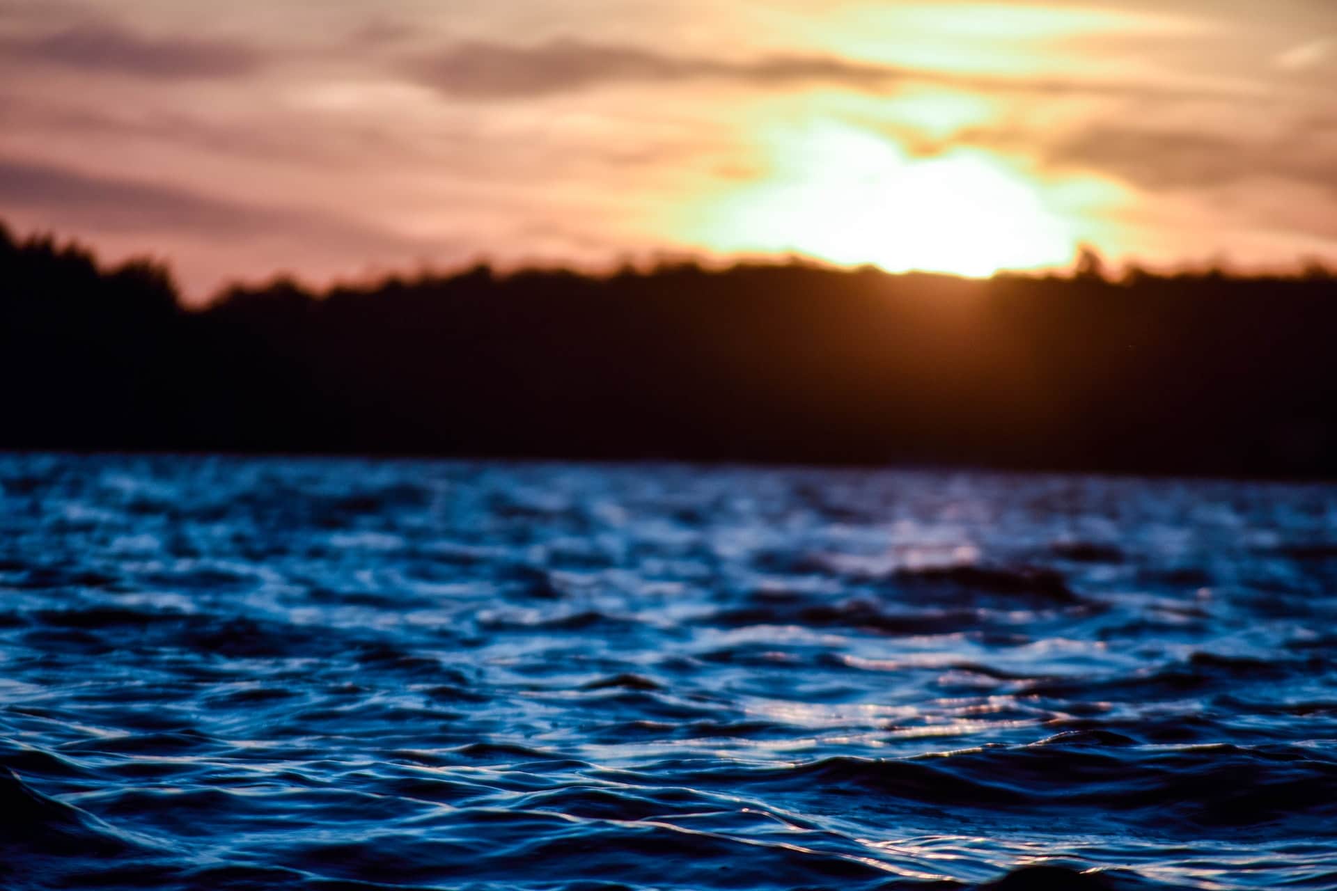 A lake at sunset representing a court using the armchair rule to interpret a will about the distribution of the proceeds of a family cottage