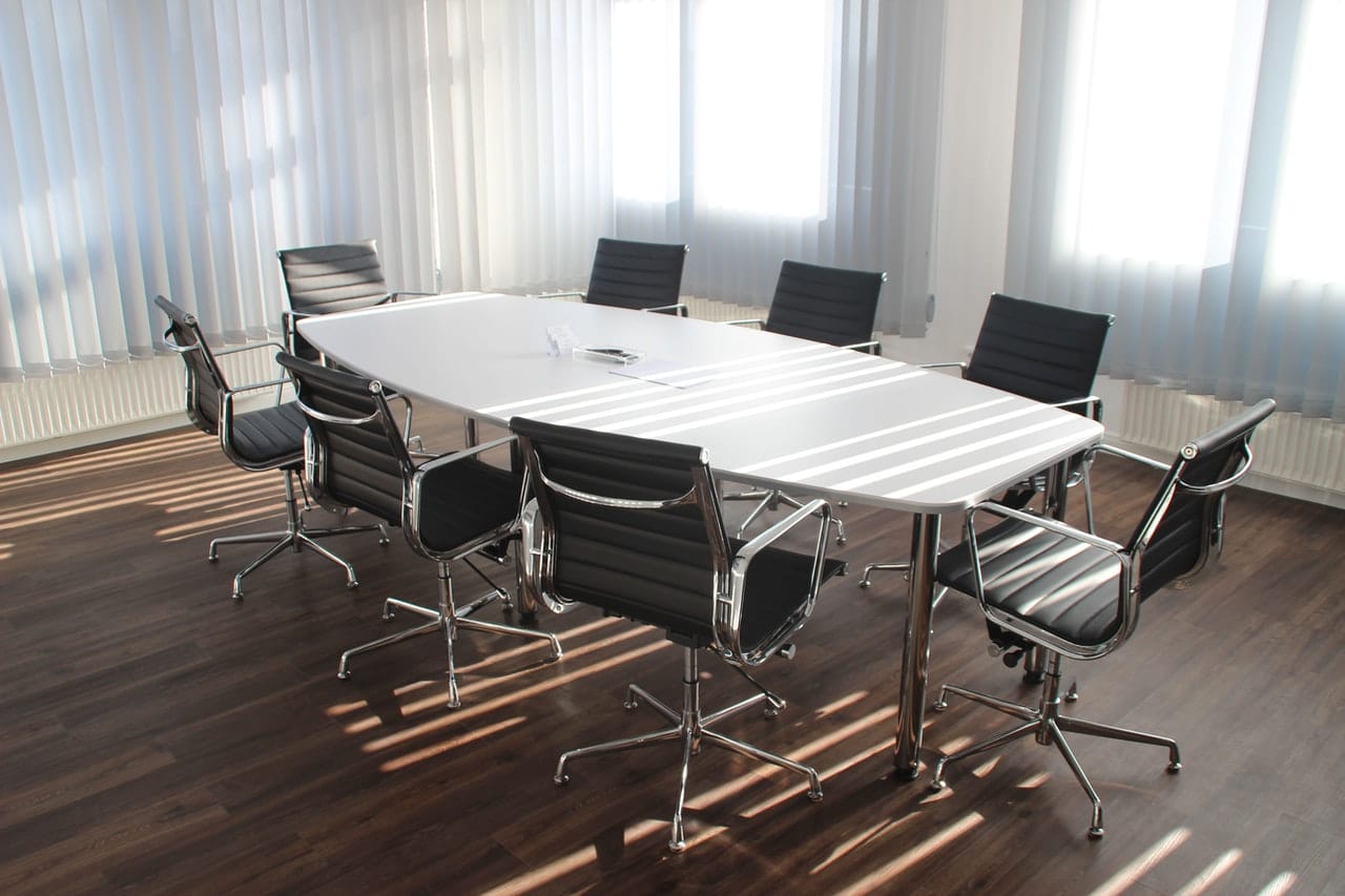 An empty conference room representing arbitration clauses in employment and other contracts