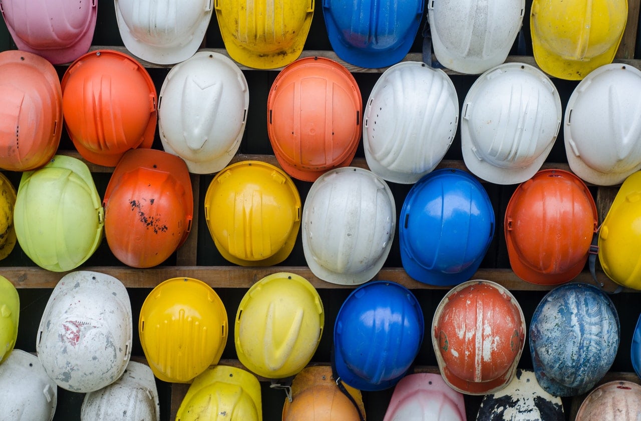 A wall of hard hats, representing how to identify the employer on a construction site