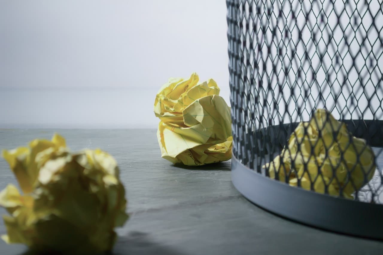 Crumpled paper in trash can representing a case where defendants in a dog bite claim were ordered to pay