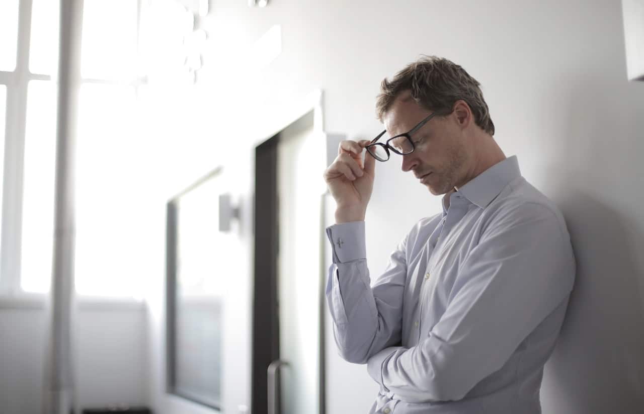 man leaning against wall