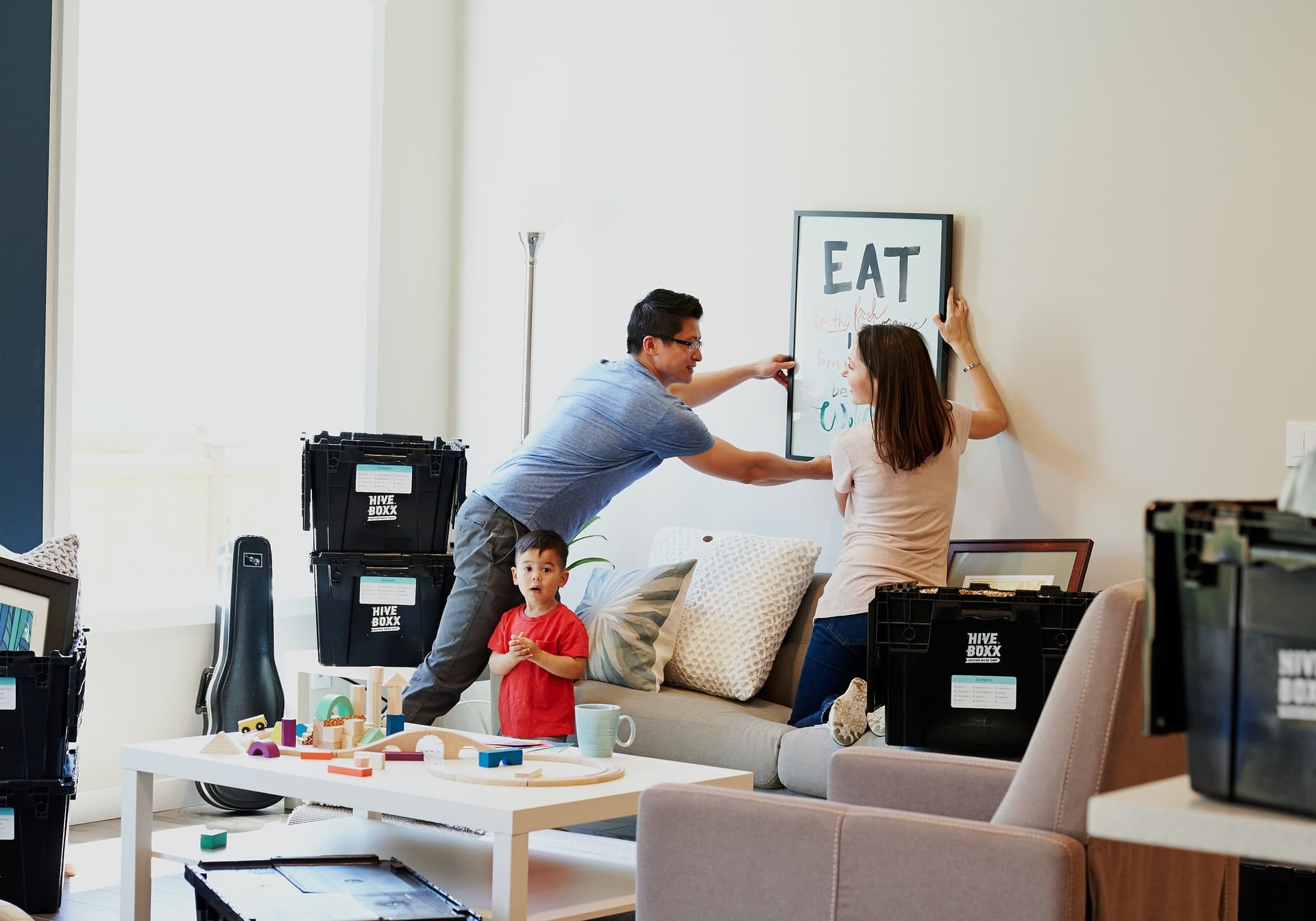 family of three moving moving into home