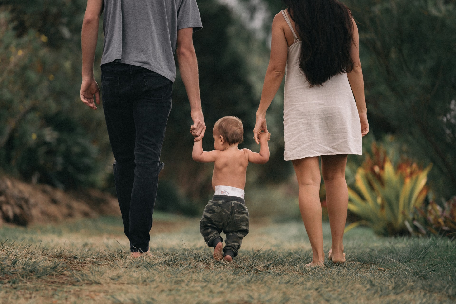 parents walking with baby