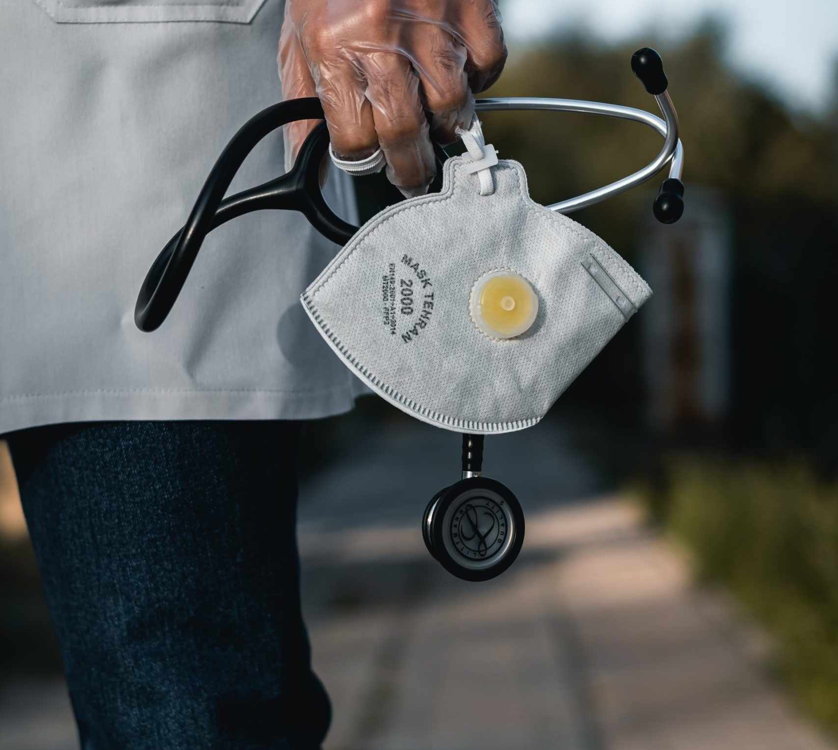 Medical doctor holds mask and stethoscope