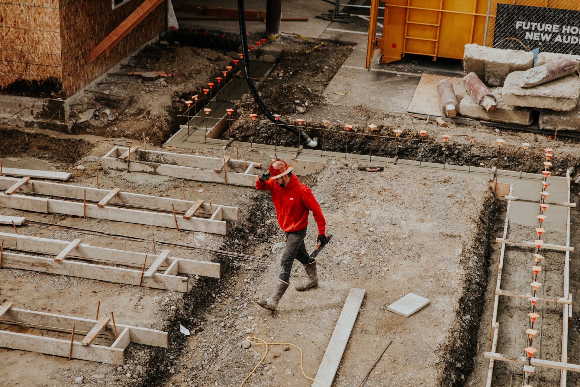 man in red jacket at construction stie