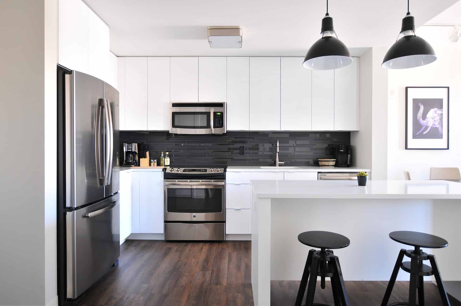 a white kitchen with black fixtures