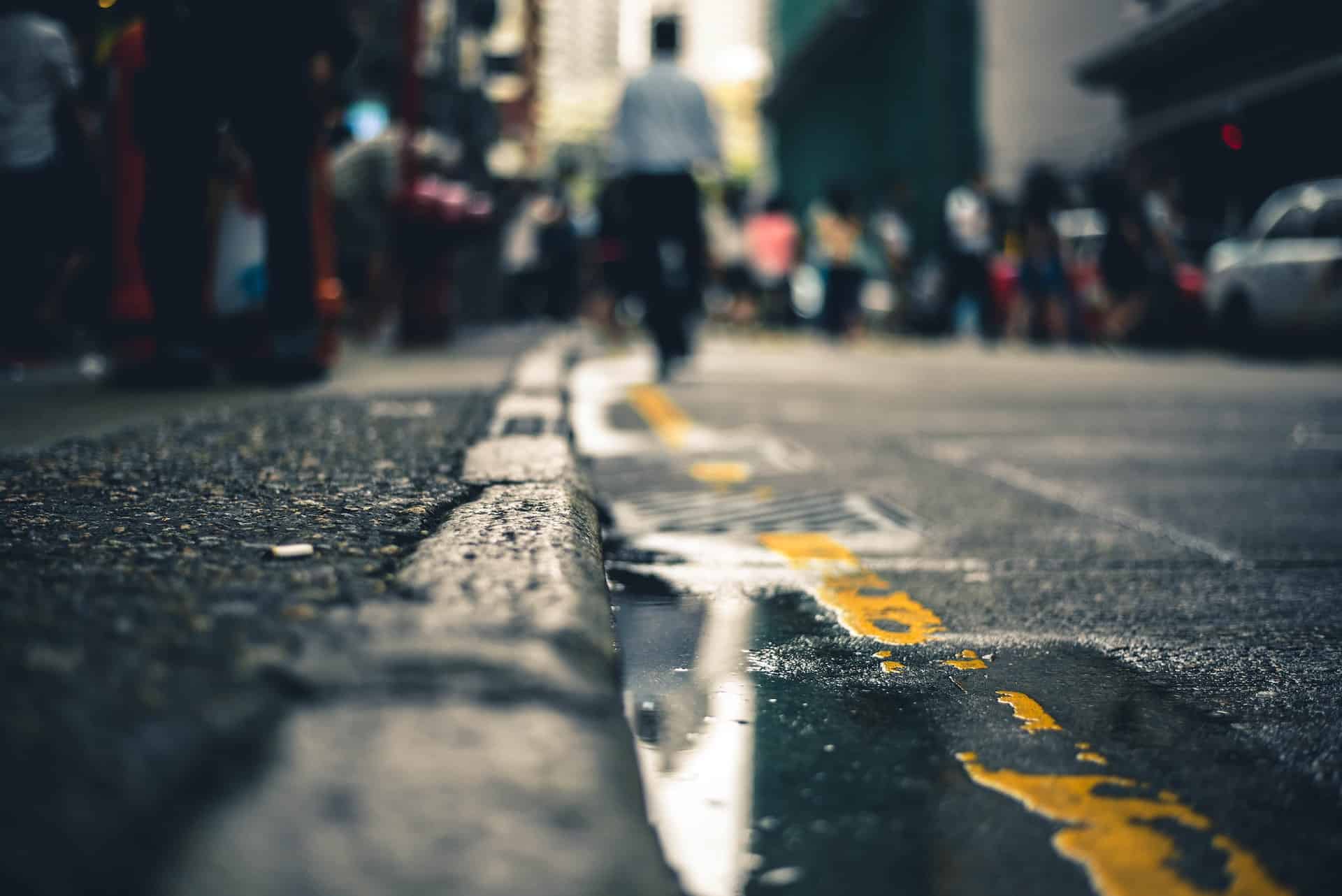 an edge of a sidewalk and road