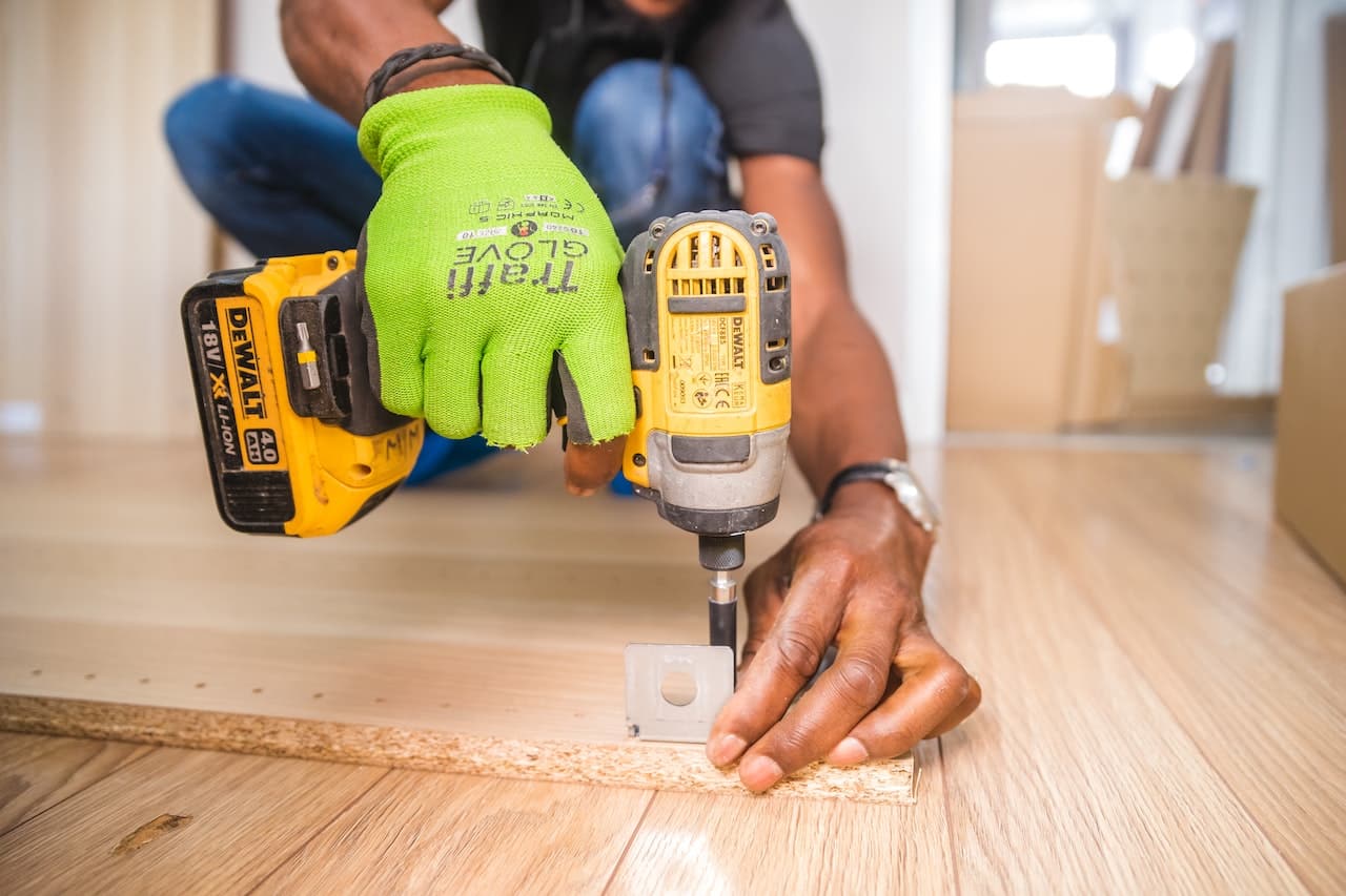 person using cordless drill