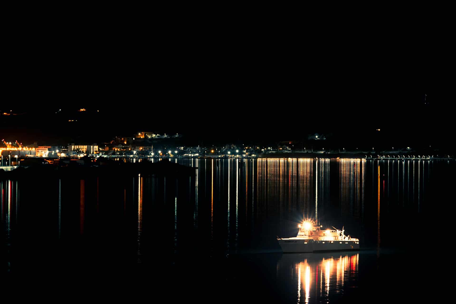 boat with lights on at nighttime