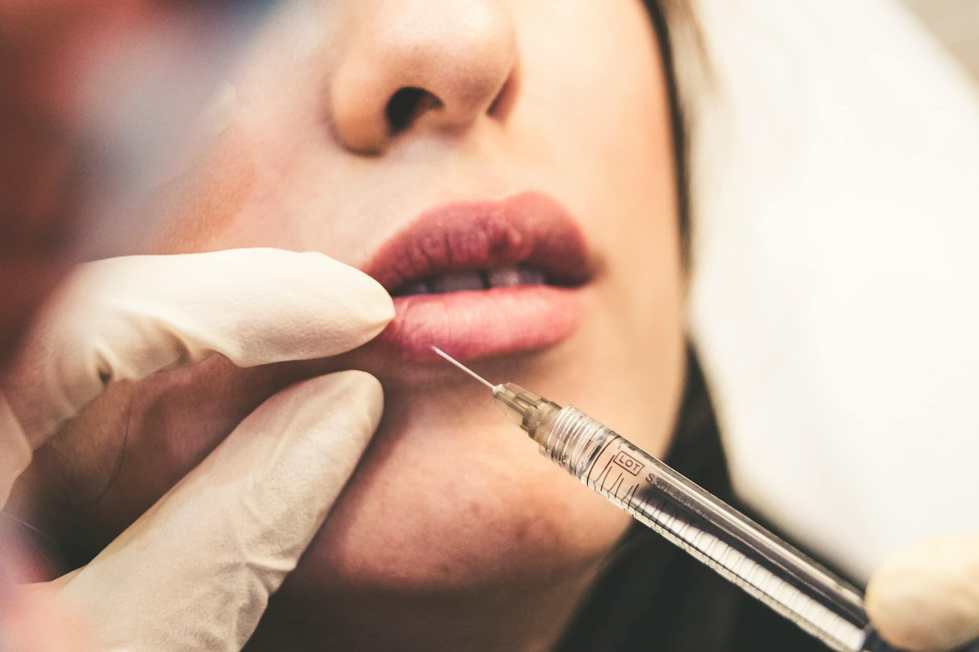 a person injecting another person's lip