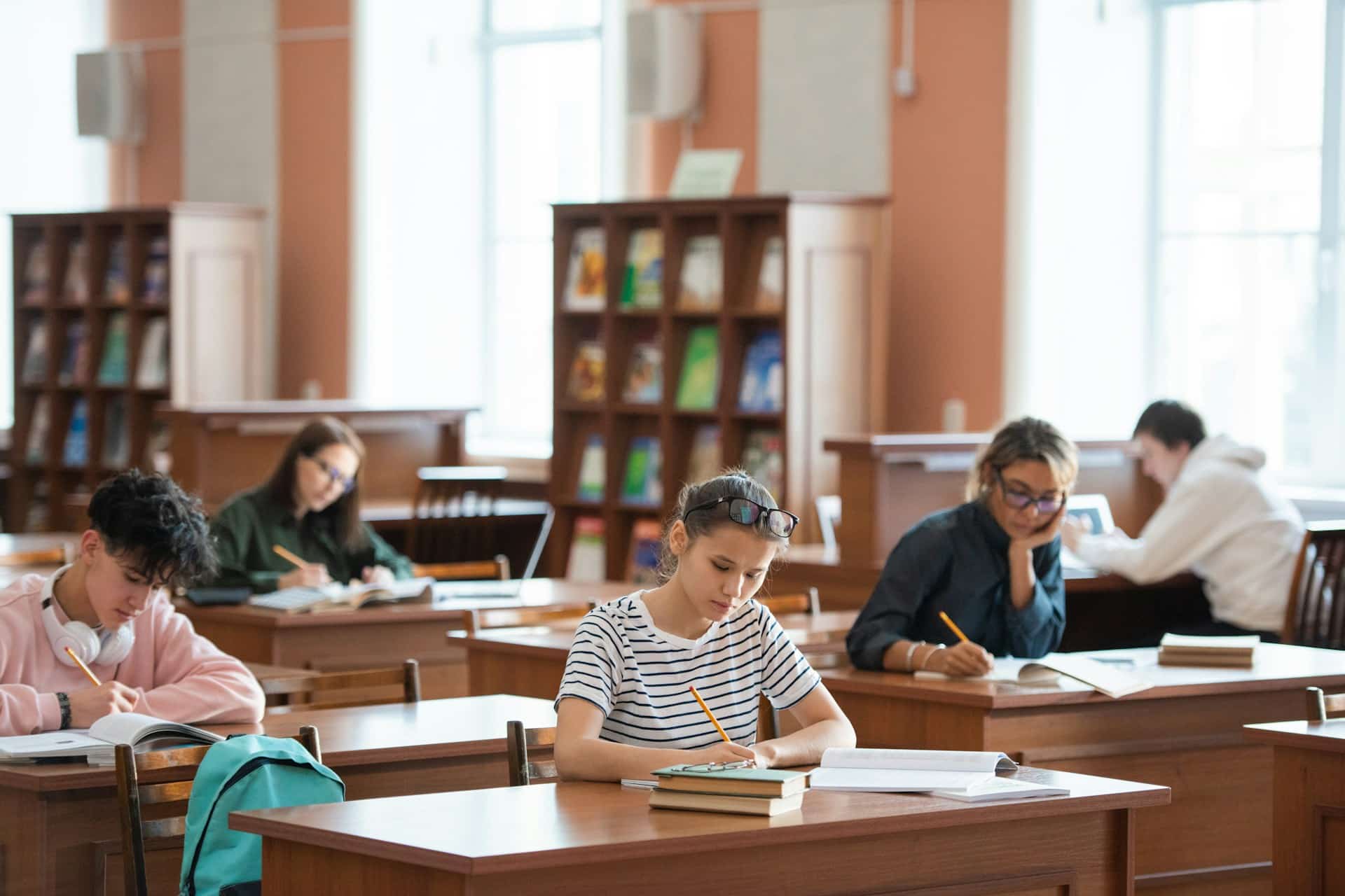 Students studying at a university library , representing university student personal injury claims.
